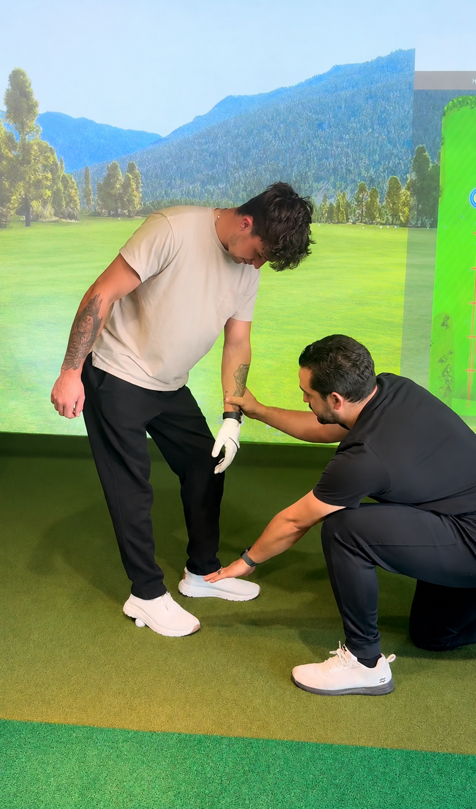 Dr. Juan Gloria assessing a golfer's lower body movement on a golf simulator in Charlotte, NC